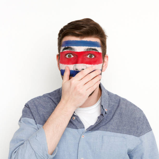 istock Young man with Costa Rica flag painted on his face 950791000