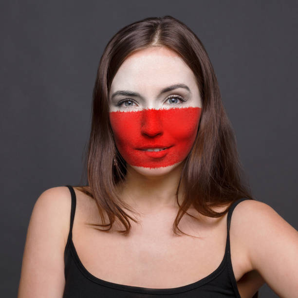 istock Young woman with Poland flag painted on her face 950791180
