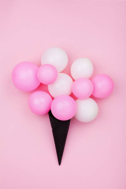 istock Minimalistic composition for birthday with balloons ice cream in waffle cone on pink pastel background top view. Flat lay. 950793662
