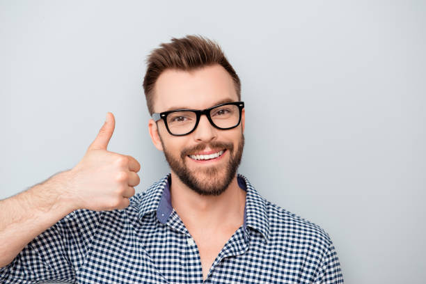 istock Happy young smiling man in glasses showing thumb up 950797068
