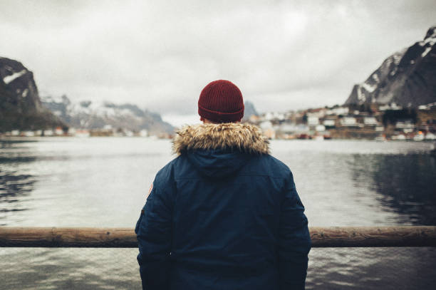 old fishing port by the fjord on lofoten islands in norway - explorer tourist frowning men imagens e fotografias de stock