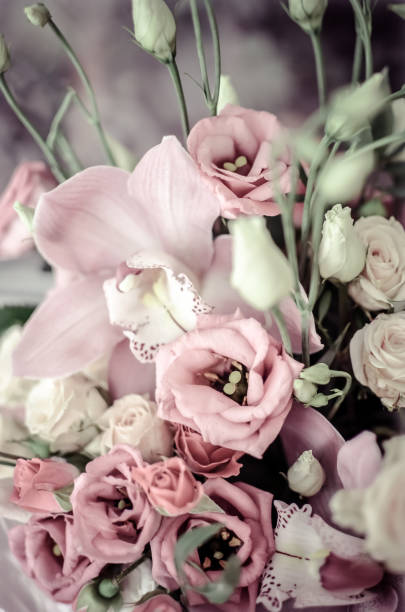 istock Bouquet with orchids and roses on a beautiful background 950802842