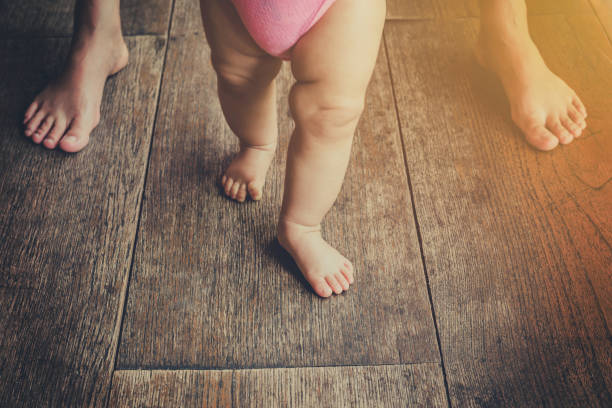 istock Baby leaning walking with mother, vintage toned. 950803554