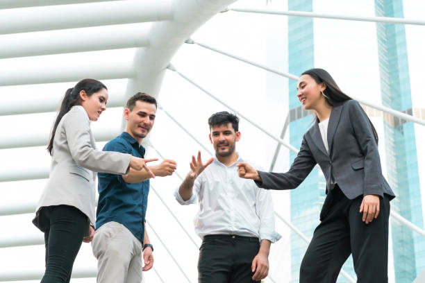 istock Business people show rock, paper and scissors at outdoors. concept game, creative, playing, teamwork, brainstorm, attractive, activities, unity, power team, relationship and personnel selection. 950806628