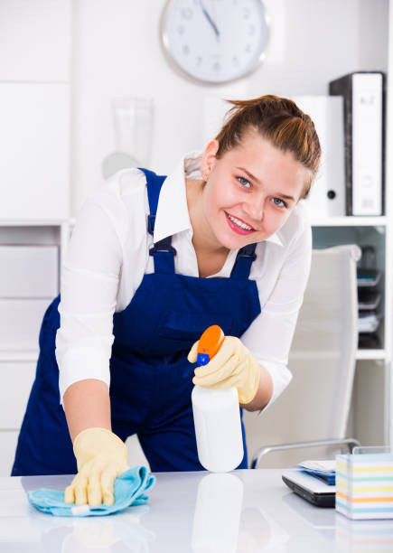 istock Happy housekeeper is cleaning dust from the desk 950806966