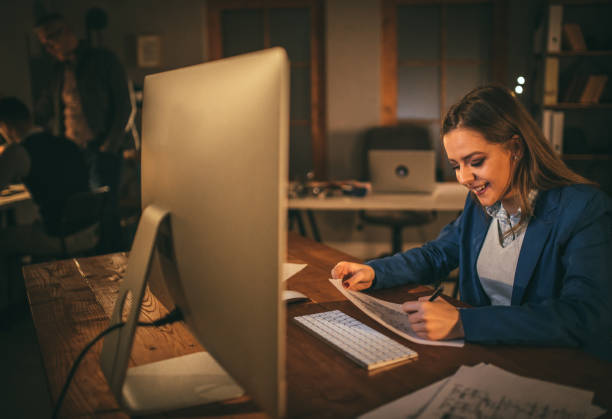istock Young woman working late 950807290