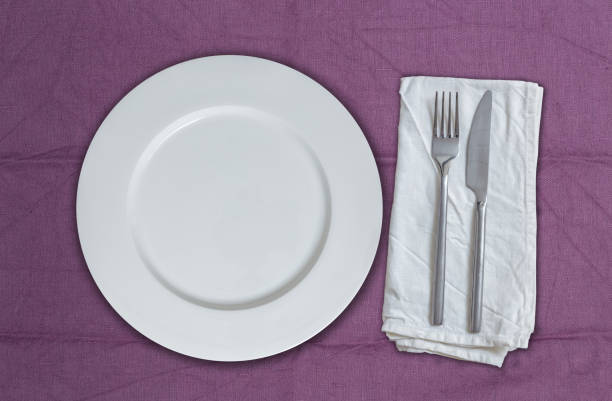istock Empty plate and cutlery on violet cloth 950810284