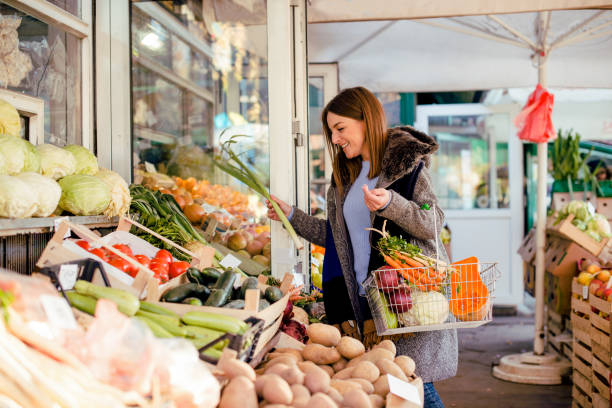 istock Smiling woman buying various vegetables 950811452