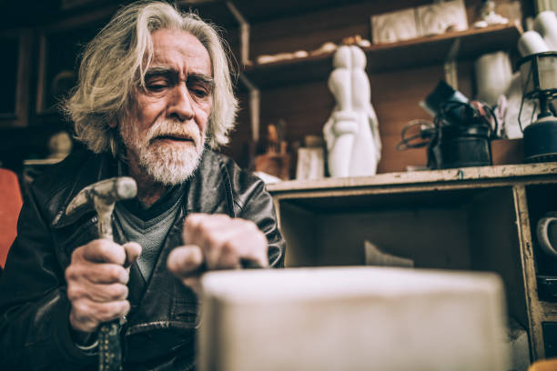 istock Senior Stonecutter working indoors 950816830