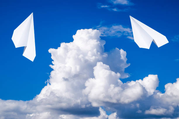 istock White paper airplane in a blue sky with clouds. The message symbol in the messenger 950819800