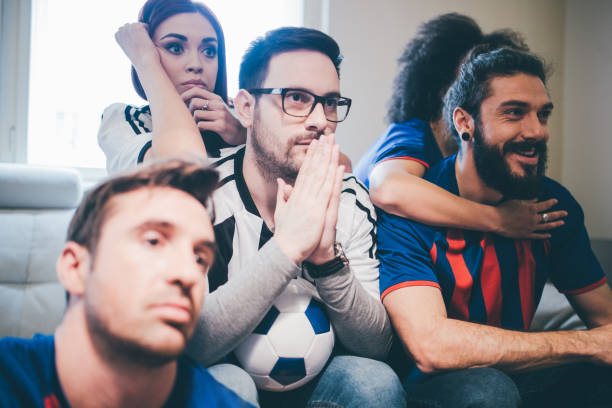 istock Multi-gender group of soccer fans watching a game 950819846
