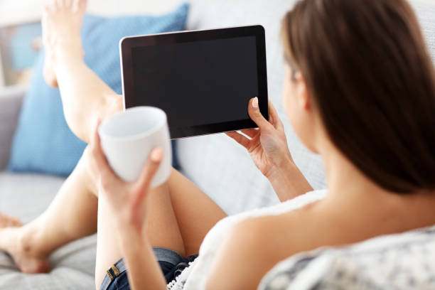 istock Happy woman relaxing at home with tablet 950820094