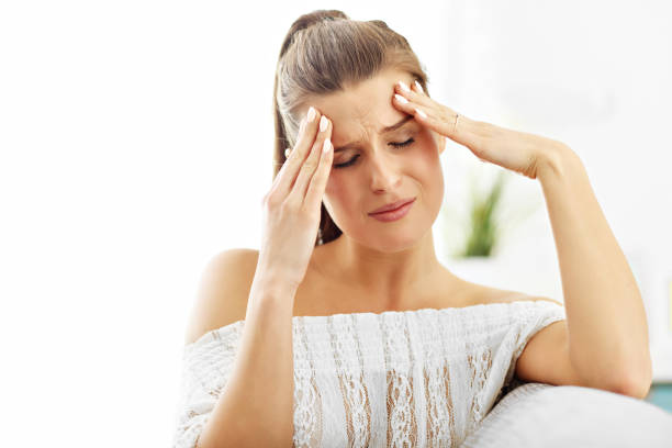 istock Happy woman suffering from headache at home 950821484