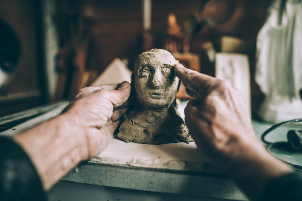 Senior man's hands making statue of clay Senior adult making art product out of clay in his workshop,senior handmade concept,personal perspective clay sculpture stock pictures, royalty-free photos & images