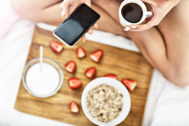 istock Young woman in bed with breakfast 950826368