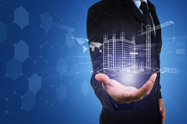 istock Businessman's hand with building construction design reality virtual technology. Building automation digital wireless control concept. 950827050