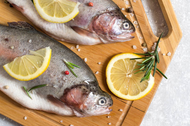 istock Two fresh trout and ingredients for cooking 950831534