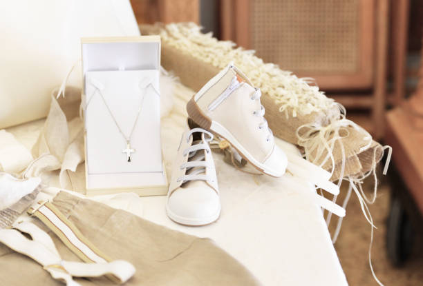 baptism baby clothes and cross baptism baby clothes and cross - greek Orthodox christening pics of the godmother stock pictures, royalty-free photos & images