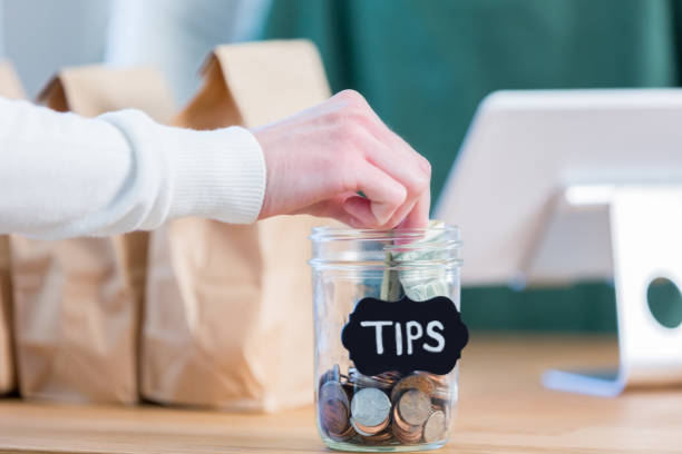istock An unrecognizable coffee shop customer adds to a tips jar 950832270