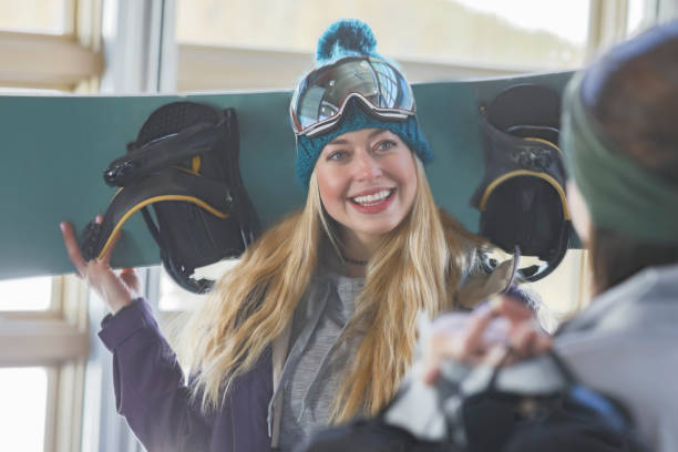 istock Woman talks with friend in ski lodge 950835340