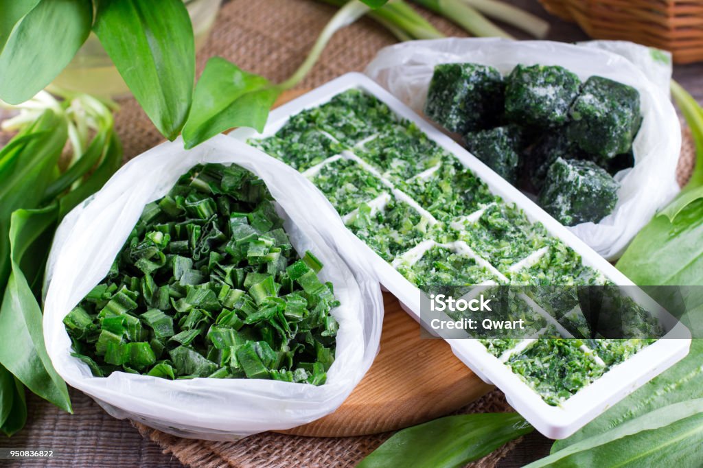 Frozen Herbs on a wooden table Frozen Herbs on a wooden background Herb Stock Photo