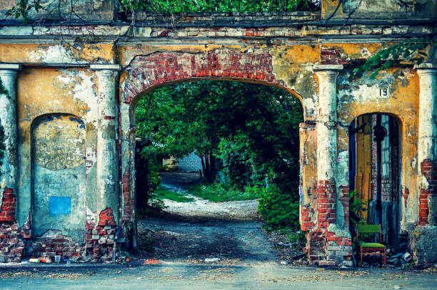 Picturesque old broken brick arch in the town yard.