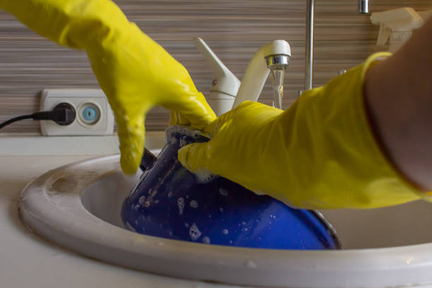 istock Washing dishes in yellow gloves 950841734