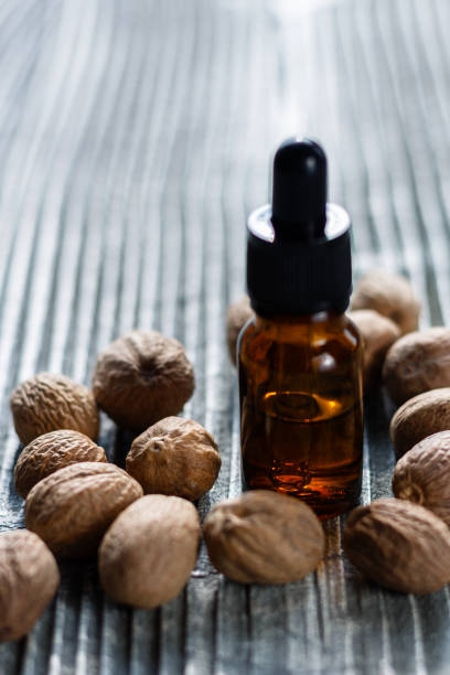 istock nutmeg essential oil on a gray wooden background 950847016