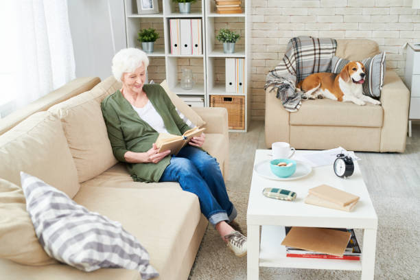 istock Happy grandmother enjoying reading 950847188