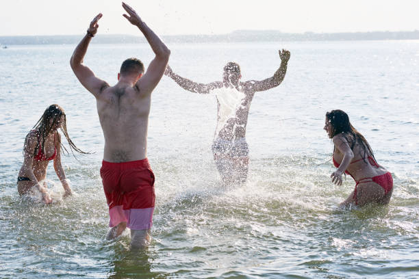 istock Carefree friends having fun in sea 950854420