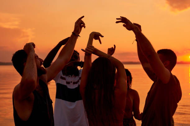 istock Carefree energetic friends dancing all night on beach 950854502