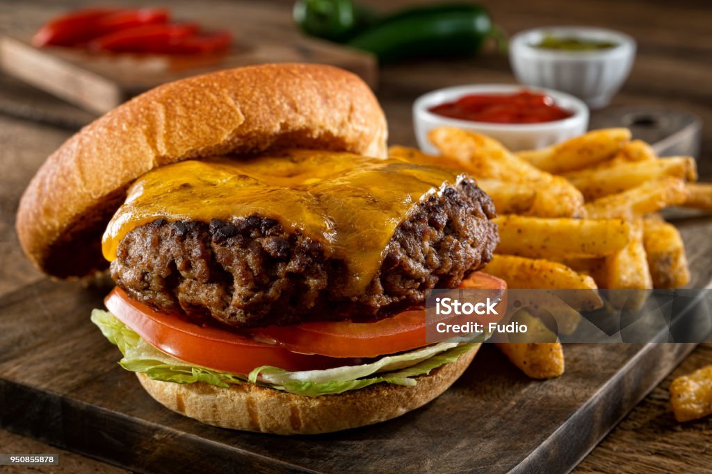Cheeseburger and Fries A delicious homemade burger with real cheddar cheese and black pepper seasoned french fries. Burger Stock Photo