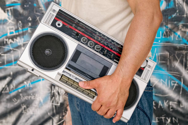istock Man holding vintage tape boombox 950857550