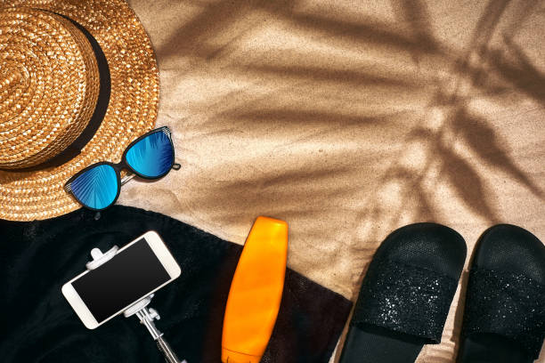 istock Summer background with straw hat, sunglasses, sunscreen bottle and flip flops 950859036