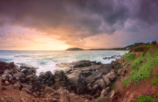 istock Tropical beach with rocks on sand coast of ocean 950860988
