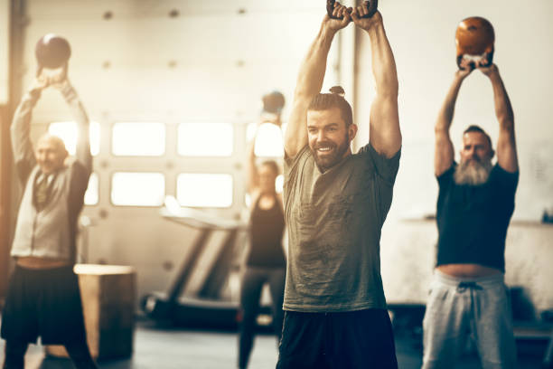 istock People working out during a weight session at the gym 950865202