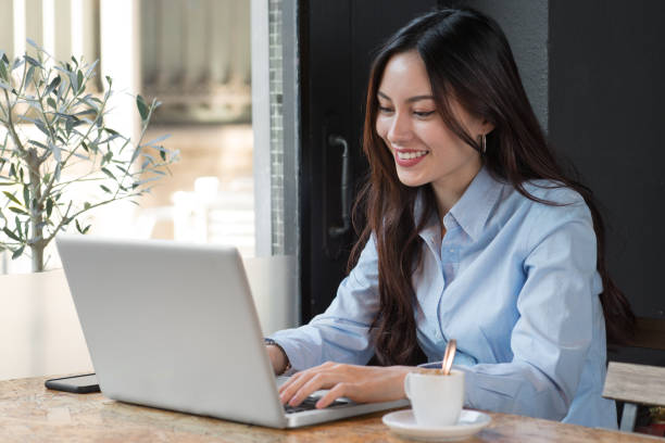 istock Attractive woman with computer in cafeteria 950865204