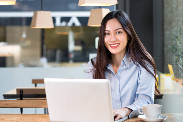 istock Attractive woman with computer in cafeteria 950865210