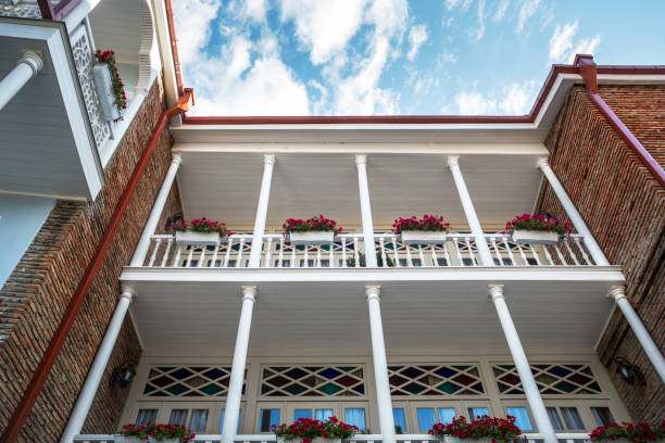 istock Beautiful white balcony with flowers under blue sky. 950865446