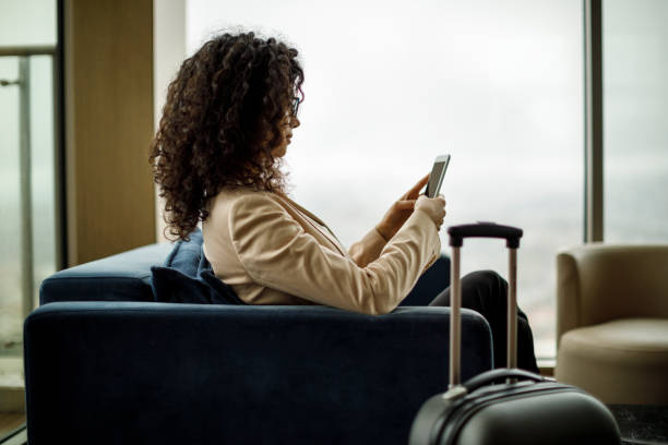istock Businessman using mobile phone in airport waiting area 950866270