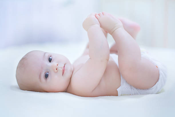 Adorable little baby boy wearing a diaper stock photo