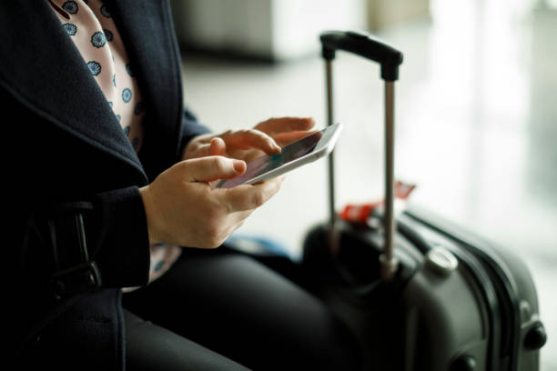 istock Businesswoman texting while waiting for a flight at airport 950866700