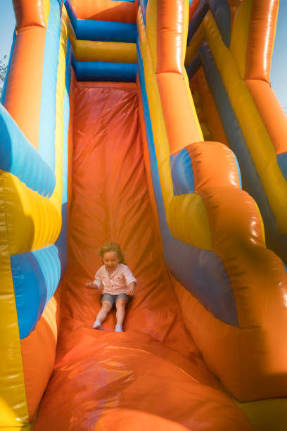 istock Little kid having fun in inflatable castle playground 950866728
