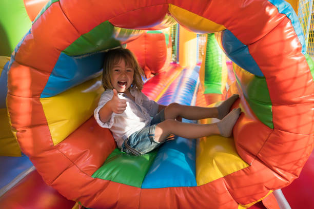 istock Little kid having fun in inflatable castle playground 950866882