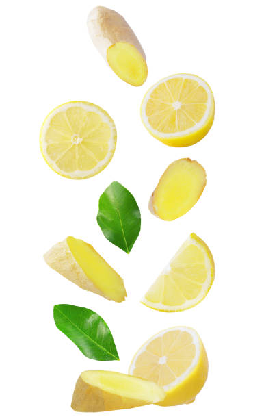 Isolated flying fruits. Falling lemon and ginger isolated on white background with clipping path as package design element and advertising stock photo