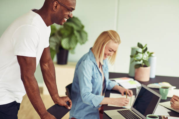 istock Two smiling business colleagues working together in an office 950875050
