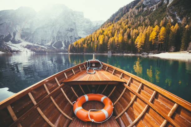 istock Traditional rowing boat on a lake in the Alps in fall 950882534