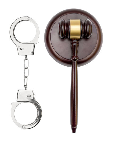 istock Handcuffs with judge's gavel on white background. Top view. Law concept. 950883352