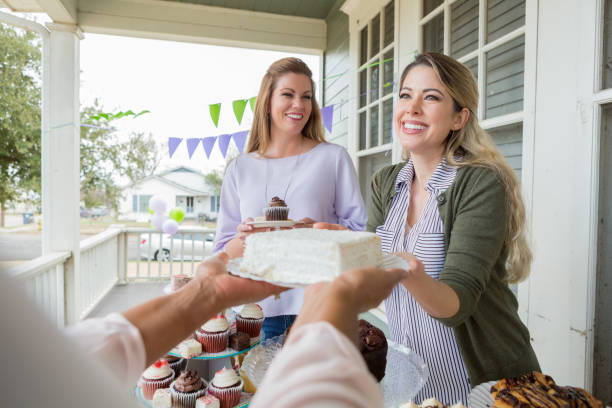 istock Unrecognizable woman donates cake during charity event 950886846