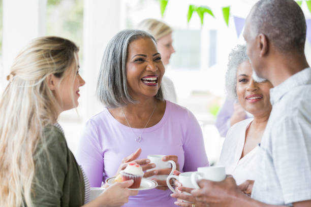 istock Cheerful adults attend cancer awareness fundraiser 950886882